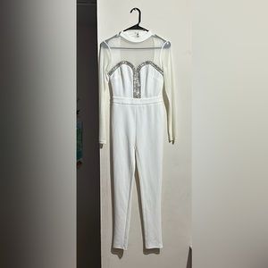NWT white jumpsuit with sheer arms and dazzling rhinestones